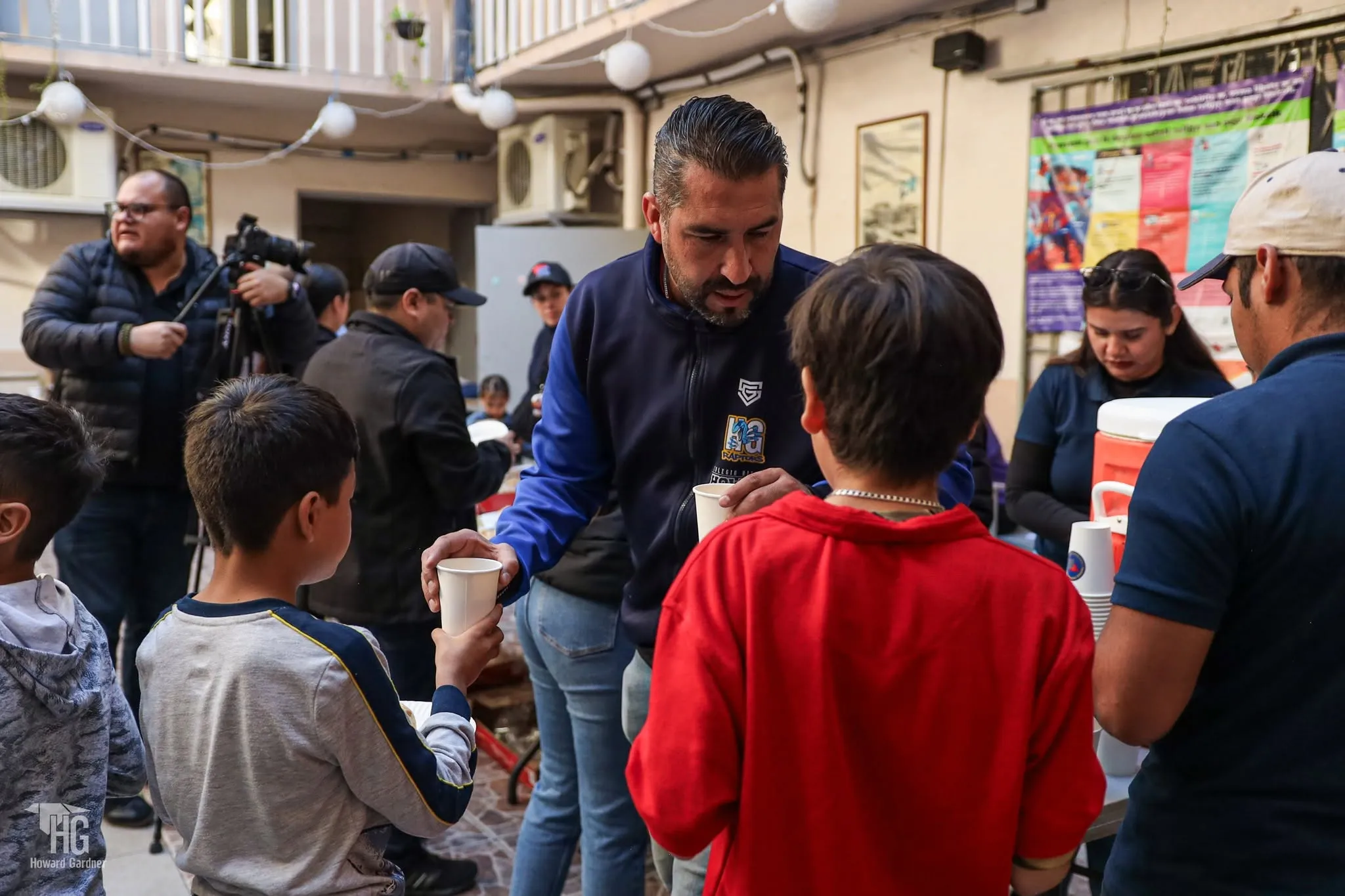 Niños reciben alimento de un voluntario